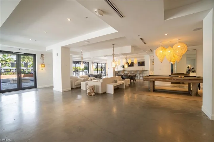 Spacious common area featuring polished concrete flooring and shiplap accent walls
