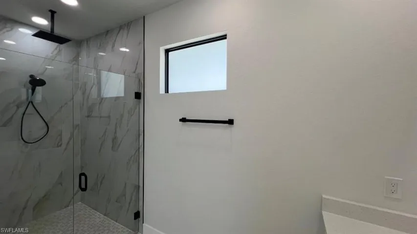 Bathroom with a marble finish shower