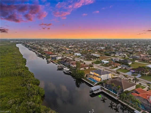 Aerial view at dusk of a water view and a residential view