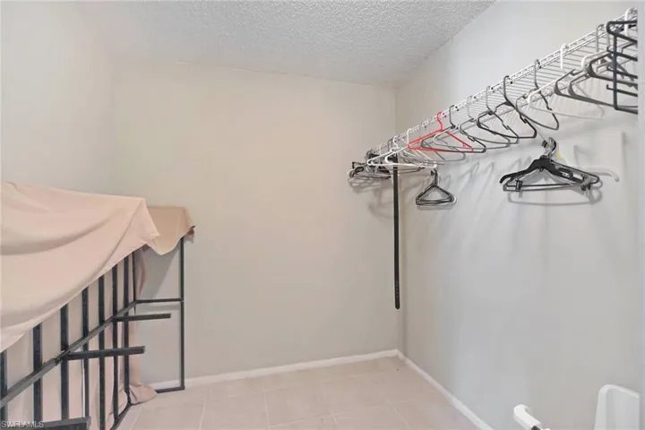 Walk in closet with light tile  floors