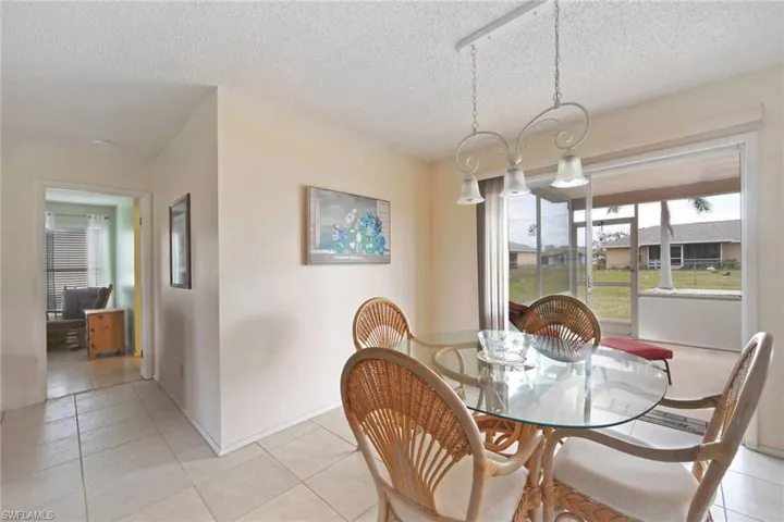 Dining space featuring light tile  floors and a textured ceiling