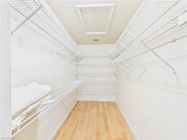 Spacious closet featuring visible vents and wood finished floors