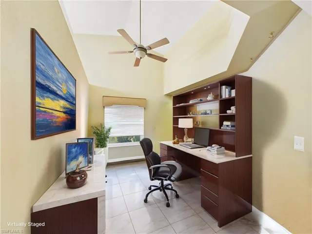 Office with baseboards, a ceiling fan, and high vaulted ceiling