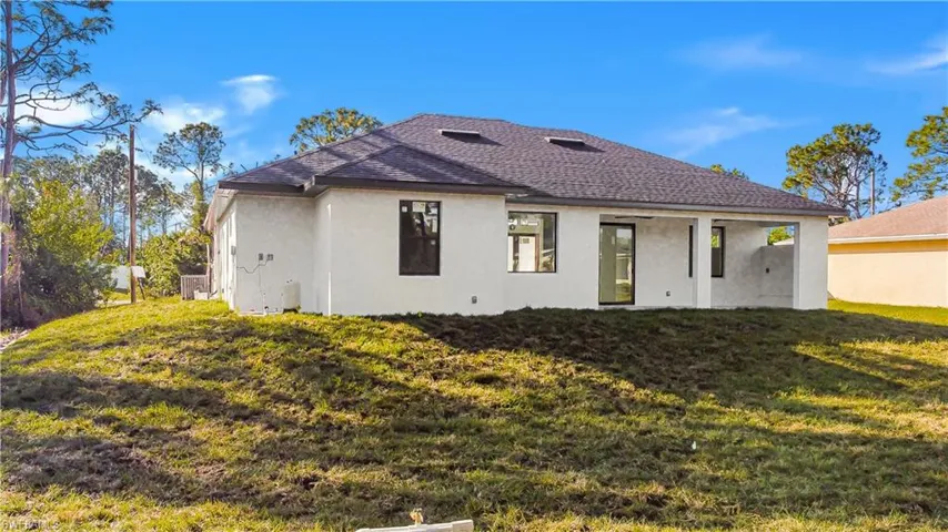 Back of property with a yard