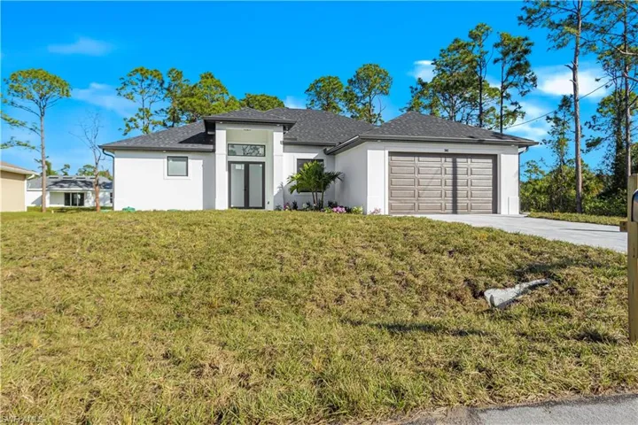 View of front facade with a front yard and a garage