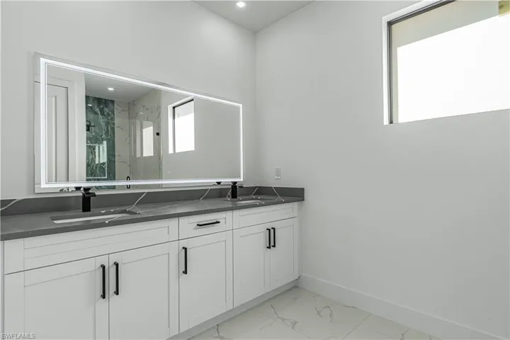 Bathroom with vanity and an enclosed shower