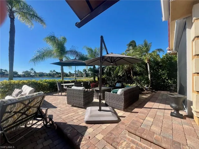 View of patio featuring an outdoor hangout area, a water view, and outdoor dining area