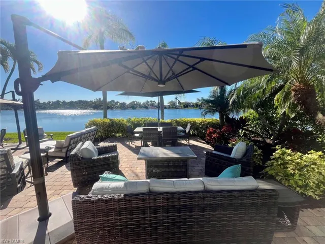 View of patio featuring outdoor dining area, a water view, and outdoor lounge area