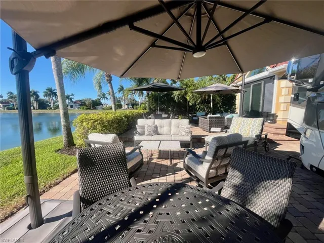 View of patio with a water view and an outdoor hangout area