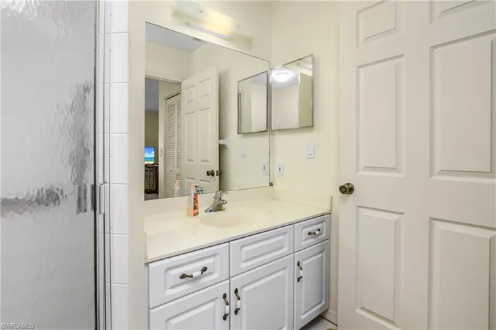 Bathroom featuring vanity and an enclosed shower