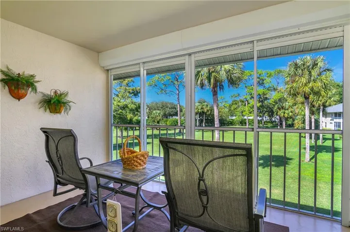 Sunroom / solarium with view of wooded area
