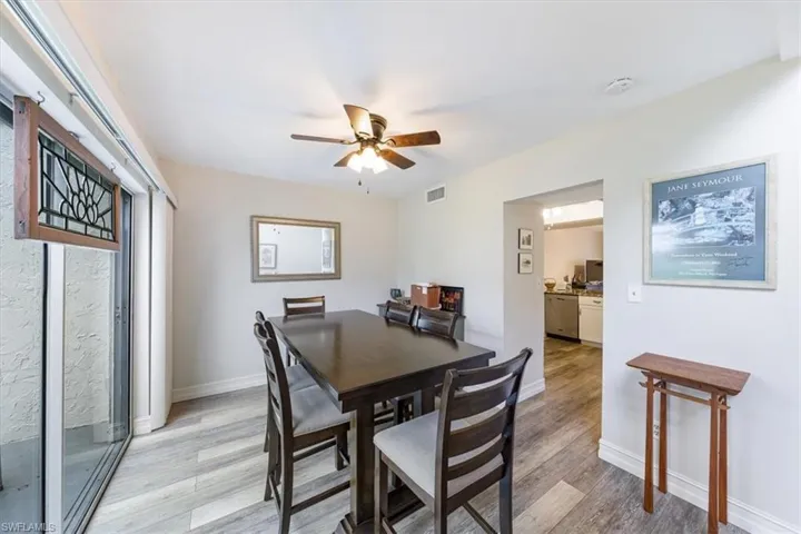 Dining space with light wood finished floors and a ceiling fan
