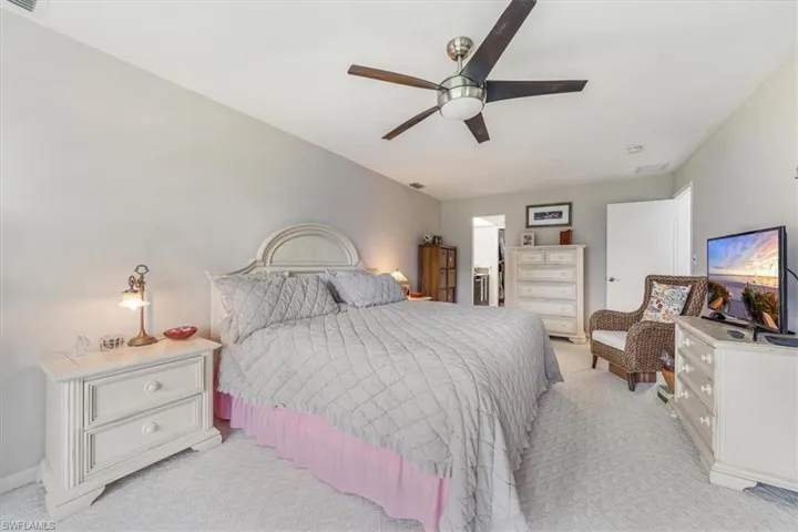 Bedroom featuring light colored carpet and a ceiling fan