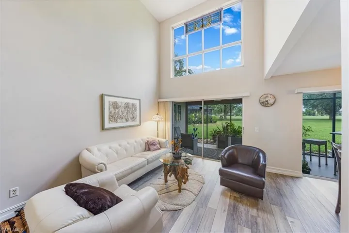 Living area with high vaulted ceiling and wood finished floors