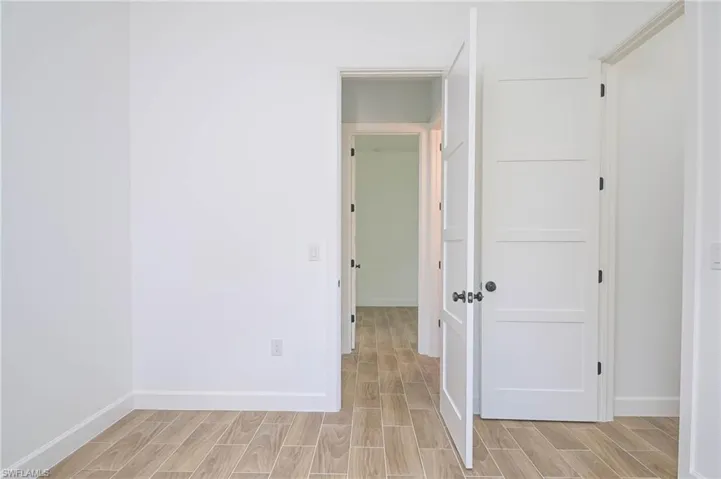 Empty room with light hardwood / wood-style flooring