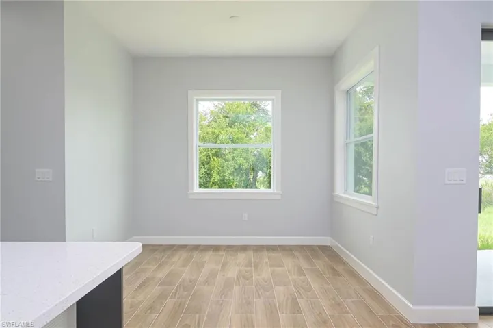 Unfurnished dining area featuring a healthy amount of sunlight and light wood-type flooring