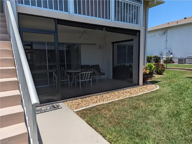 Entrance to property featuring a ceiling fan