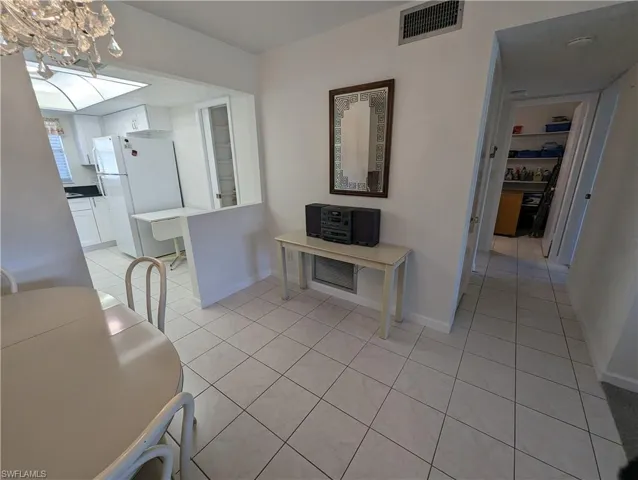 Hallway with light tile patterned floors