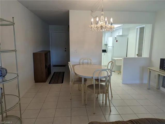Dining space featuring light tile patterned flooring and suspended lighting