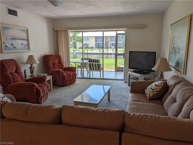 Carpeted living area with a textured ceiling