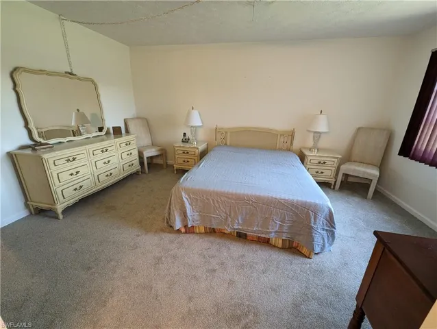 Carpeted bedroom featuring baseboards