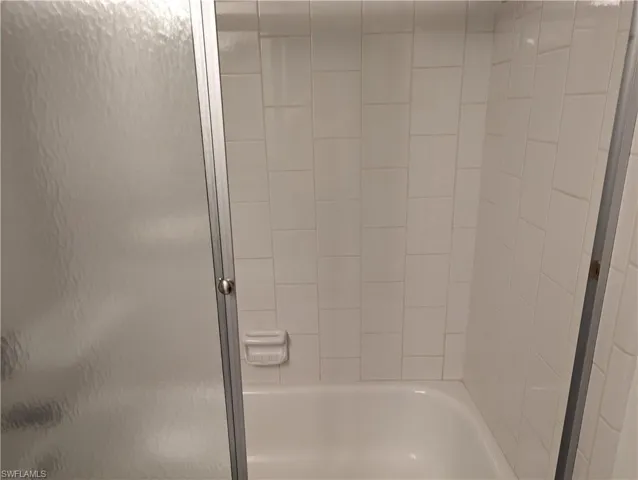 Bathroom featuring enclosed tub / shower combo