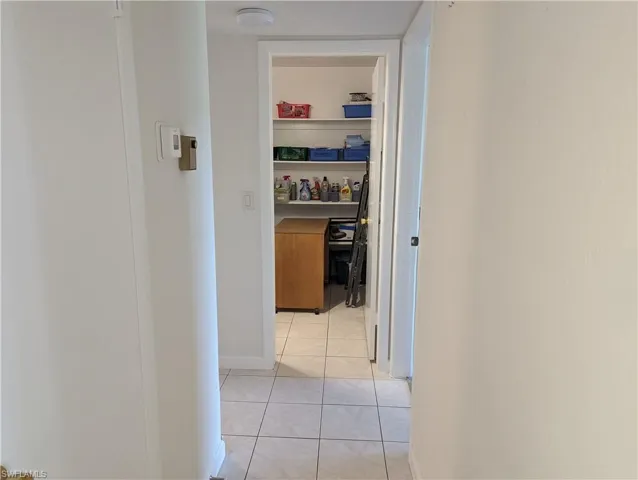 Hall with light tile patterned floors