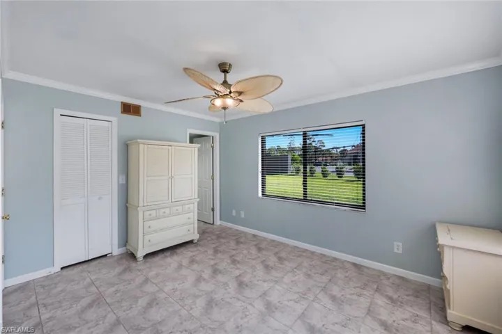 Room featuring tile flooring, white baseboards, and light blue walls