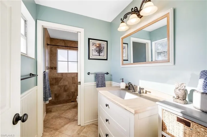 Bathroom featuring vanity and tiled shower