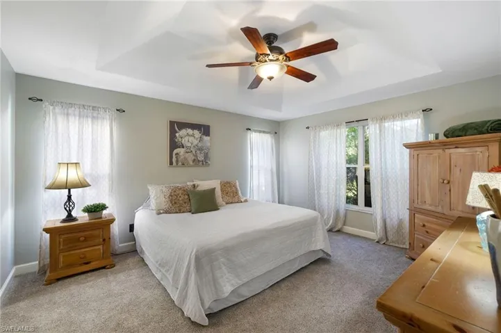 Ground floor main bedroom suite with tray ceiling, and ceiling fan