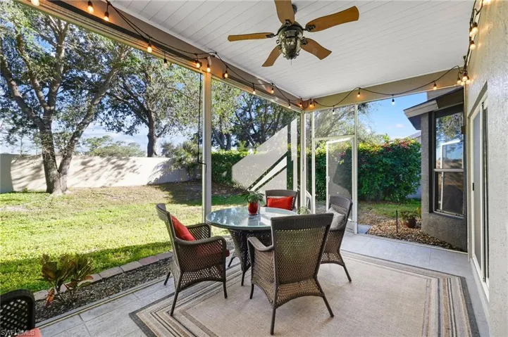 Screened Covered Patio with roll down blinds and private yard