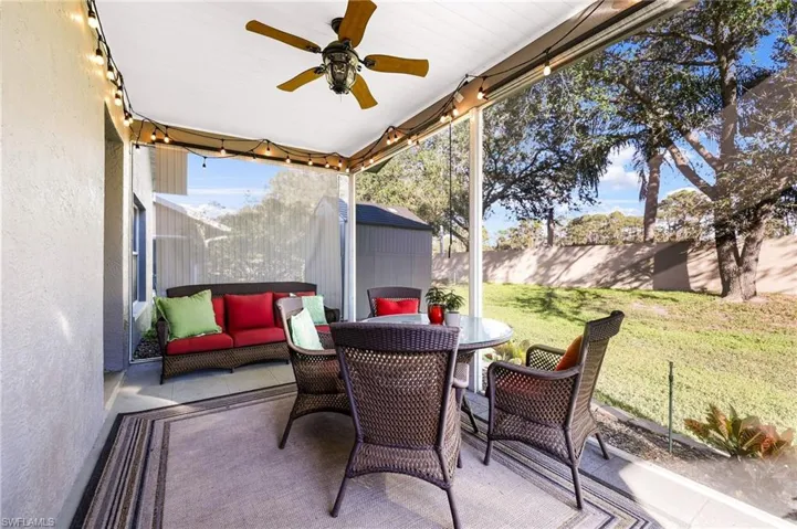 Covered and Screened Patio with roll down blinds and private yard with storage shed