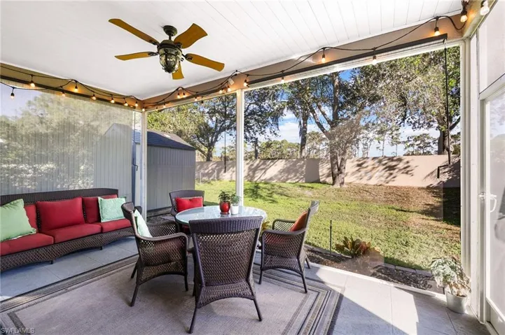 Screened Covered Pation with roll down blinds and private yard with storage shed