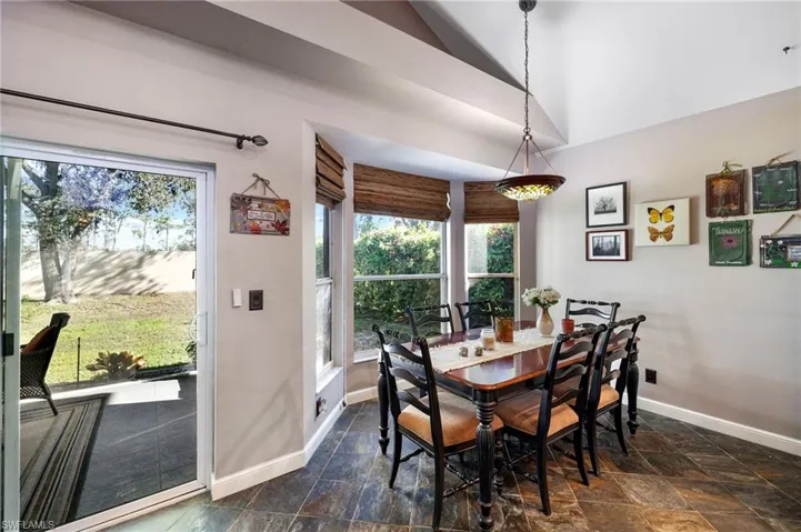 Dining room with vaulted ceiling and a healthy amount of sunlight