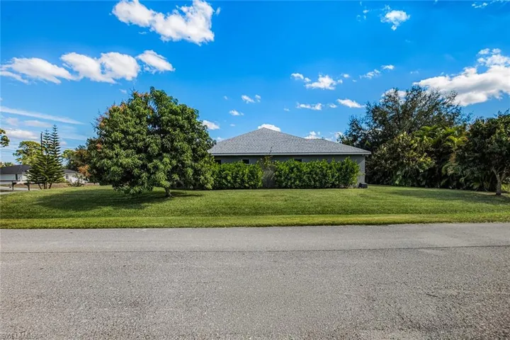 View of side of home with a lawn