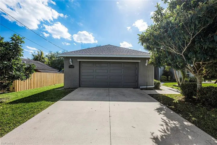 Garage featuring concrete driveway