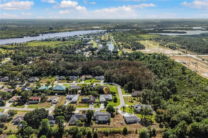 Aerial perspective of suburban area featuring a large body of water