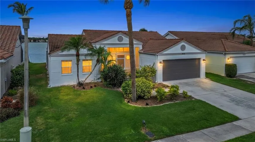 Mediterranean / spanish-style home with driveway, a tile roof, a garage, stucco siding, and a lawn