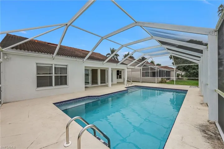 Swimming pool with a sunroom, a patio, and a lanai
