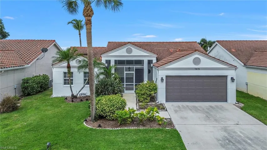 View of front of home featuring stucco siding, a tiled roof, driveway, an attached garage, and a front yard