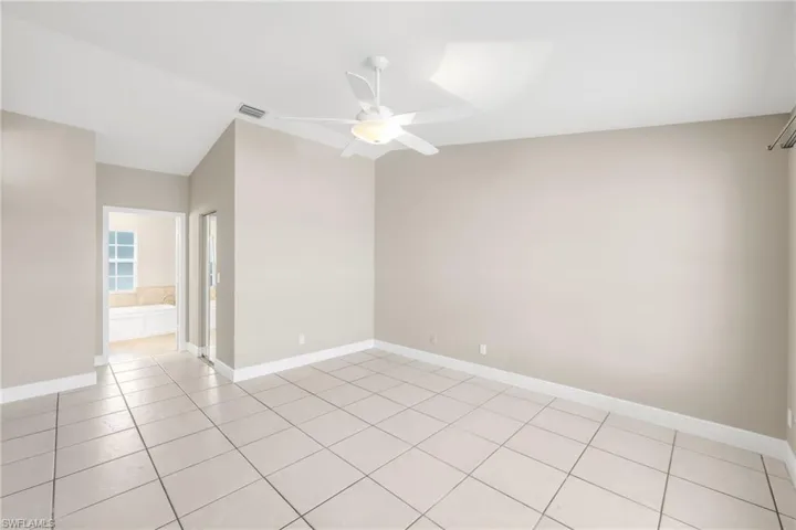 Unfurnished room featuring a ceiling fan and light tile patterned floors
