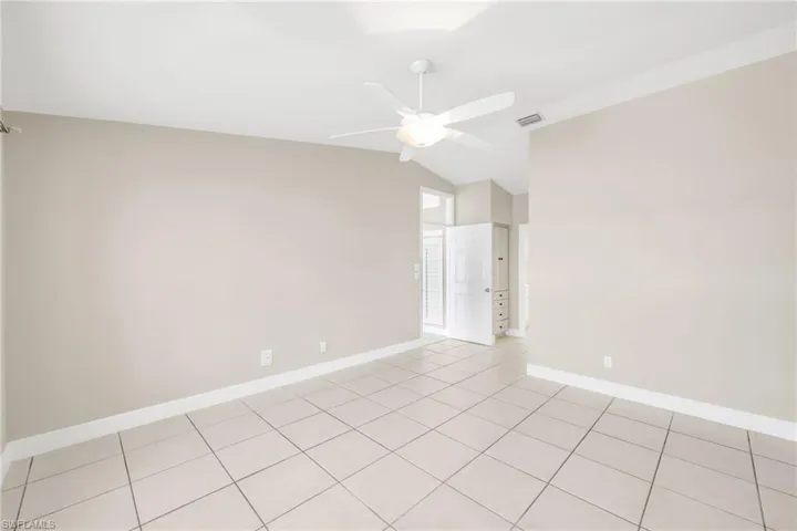 Spare room featuring a ceiling fan and lofted ceiling