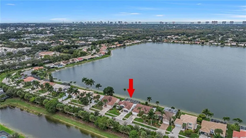 Aerial overview of property's location featuring city skyline and a large body of water