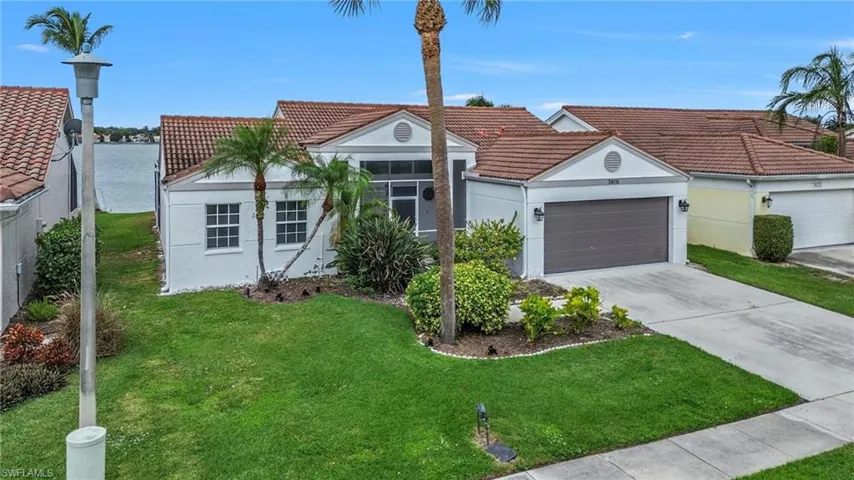 Mediterranean / spanish-style house featuring stucco siding, a tiled roof, driveway, a garage, and a front yard