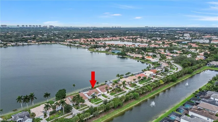 Aerial view of property's location featuring nearby urban area and a nearby body of water
