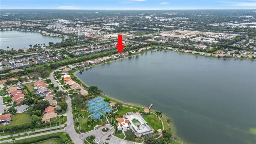 Aerial view of property's location with a large body of water