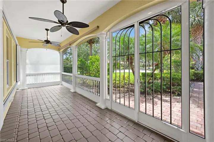 Unfurnished sunroom featuring a ceiling fan