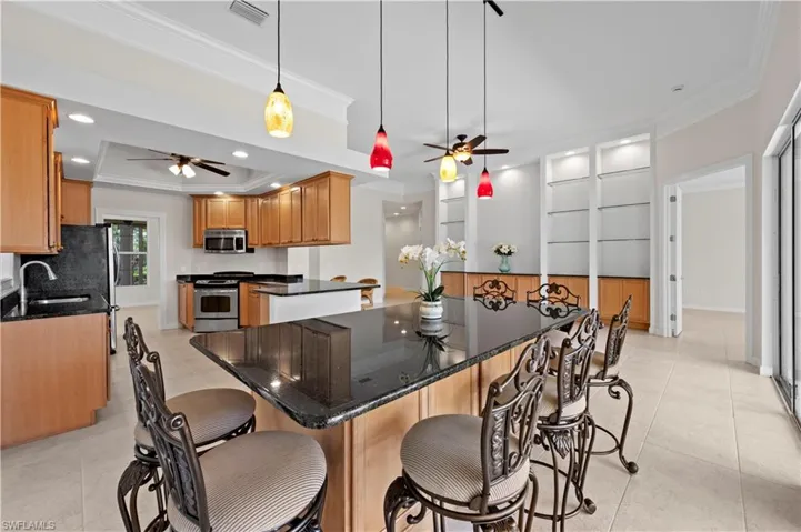 Dining area with ceiling fan, ornamental molding, light tile patterned flooring, recessed lighting, and baseboards