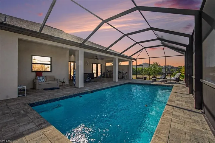 Swimming pool featuring a patio, a lanai, and an outdoor hangout area