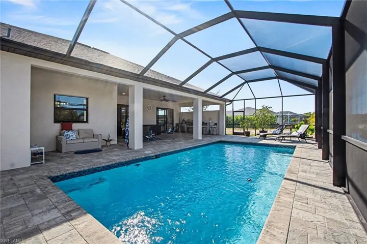 Swimming pool featuring a patio, a lanai, and an outdoor hangout area